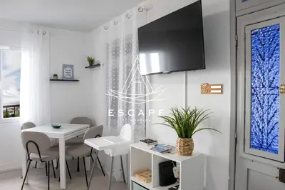 a dining room with a table and a tv on a wall at Casa Aguinha by Escape to Madeira in Arco da Calheta