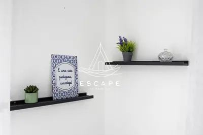 a shelf with two plants and a sign on a wall at Casa Aguinha by Escape to Madeira in Arco da Calheta