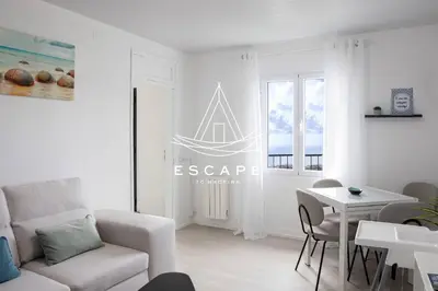 a white living room with a couch and a table at Casa Aguinha by Escape to Madeira in Arco da Calheta