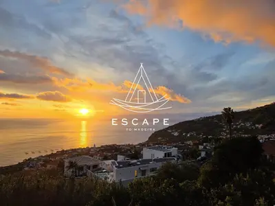 a picture of a boat in the sunset at Casa Aguinha by Escape to Madeira in Arco da Calheta