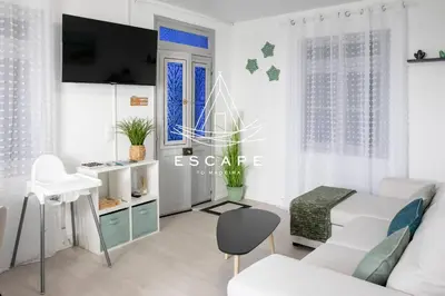 a white living room with a white couch and a table at Casa Aguinha by Escape to Madeira in Arco da Calheta