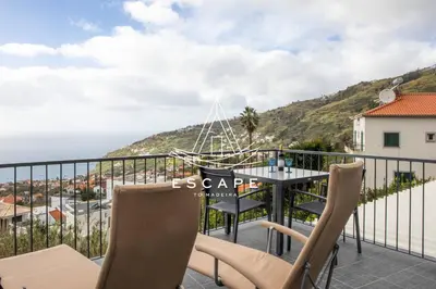 a bedroom apartment with a balcony with a view of the ocean at Casa Aguinha by Escape to Madeira in Arco da Calheta