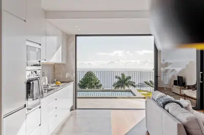 a kitchen with a large glass door leading to a pool at Atlantic Bloom by Homie in Santa Maria Maior