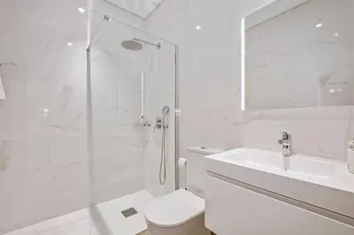 a bathroom with a shower and a toilet and a sink at Atlantic Bloom by Homie in Santa Maria Maior