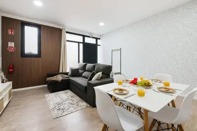 a living room with a table and a couch at Sol Blessing by GALMI in Ponta do Sol