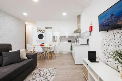 a living room with a couch and a kitchen at Sol Blessing by GALMI in Ponta do Sol