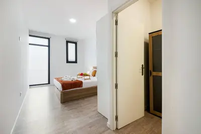 a bedroom with a bed and a sliding door at Sol Blessing by GALMI in Ponta do Sol