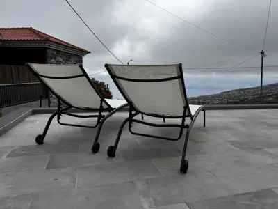 a bedroom with a bed with two towels on it at Hiking & Ocean in Arco da Calheta
