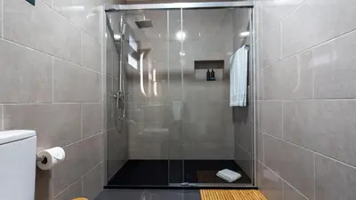 a shower with a glass door in a bathroom at Casa da Fazenda by LovelyStay in Gaula