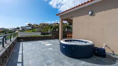 a hot tub on the patio of a house at Casa da Fazenda by LovelyStay in Gaula