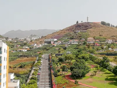 a view of a city with a train on a road at Luxury Ocean View Apartment Funchal in Funchal