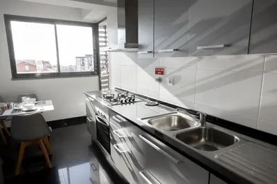 a kitchen with a stainless steel sink and a counter at Luxury Ocean View Apartment Funchal in Funchal
