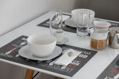 a table with plates and cups and glasses on it at Luxury Ocean View Apartment Funchal in Funchal