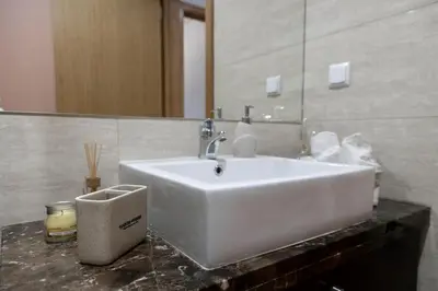 a bathroom with a white sink and a mirror at Luxury Ocean View Apartment Funchal in Funchal