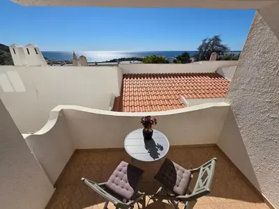a living room with a couch and a table at Casa Salema Praia Clube in Salema