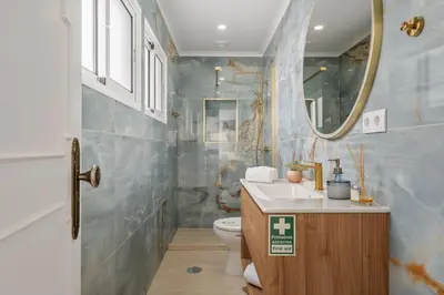 a bathroom with a toilet and a sink and a mirror at Villa Amor do Mar Ocean View, Panoramas, Jacuzzi in Funchal