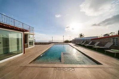 a swimming pool in the backyard of a house at Casa da Avolita, by Rent2u, Lda in Arco da Calheta