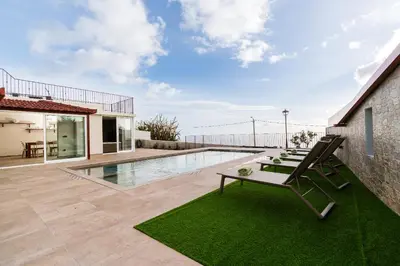 a bedroom with a large bed and a mirror at Casa da Avolita, by Rent2u, Lda in Arco da Calheta