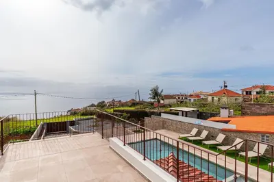 a shelf with a brick wall with an oven at Casa da Avolita, by Rent2u, Lda in Arco da Calheta
