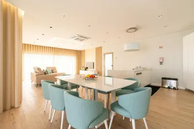 a kitchen and living room with a table and chairs at Casa Joaquim by Rent2u, Lda in Arco da Calheta