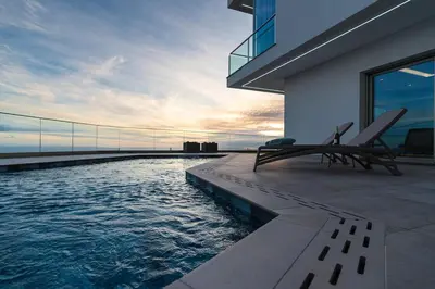 a house with a swimming pool on the side of it at Casa Joaquim by Rent2u, Lda in Arco da Calheta