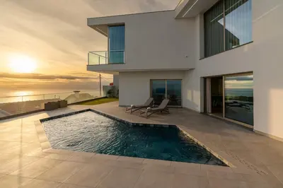 a swimming pool in the middle of a house at Casa Joaquim by Rent2u, Lda in Arco da Calheta