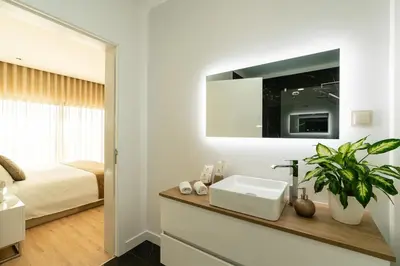 a white bathroom with a sink and a bed at Casa Joaquim by Rent2u, Lda in Arco da Calheta