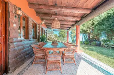 an outdoor table and chairs on a patio at Quintinha de São Jorge in Santana
