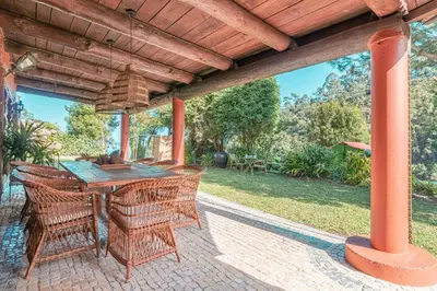 an outdoor table and chairs on a patio at Quintinha de São Jorge in Santana