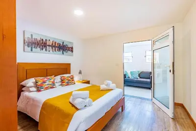 a bedroom with a large bed with towels on it at Casa do Manuel Maria in Estreito da Calheta
