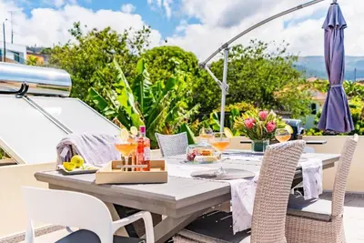 an outdoor table with food and drinks on a boat at Casa do Manuel Maria in Estreito da Calheta