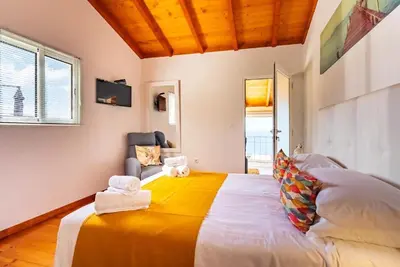 a bedroom with a large bed with towels on it at Casa do Manuel Maria in Estreito da Calheta