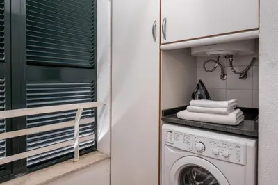 a laundry room with a washer and dryer at White House I Apartment with Garden View in Funchal