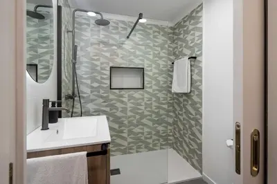 a bathroom with a shower and a white sink at White House I Apartment with Garden View in Funchal