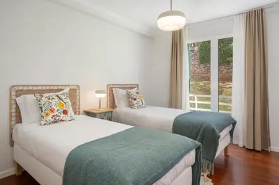 a bedroom with two beds and a window at White House I Apartment with Garden View in Funchal