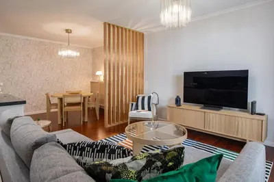 a living room with a couch and a tv at White House I Apartment with Garden View in Funchal