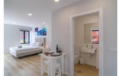 a white bathroom with a sink and a mirror at Casa AZUL Apartments in Jardim do Mar