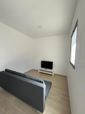 a living room with a couch and a tv at Cozy Noia in Machico