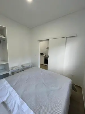 a white bedroom with a large bed in it at Cozy Noia in Machico
