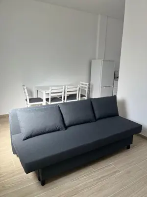 a couch in a living room with a table at Cozy Noia in Machico