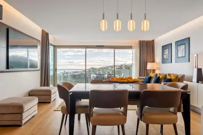 a living room with a dining room table and chairs at Half Gate Villa in Gaula