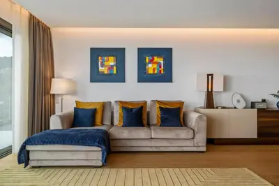 a living room with a couch and blue pillows at Half Gate Villa in Gaula