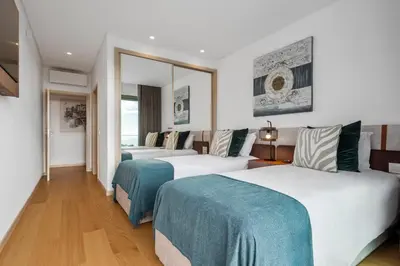 a hotel room with two beds and a mirror at Half Gate Villa in Gaula