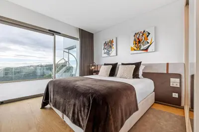 a bedroom with a large bed and a large window at Half Gate Villa in Gaula