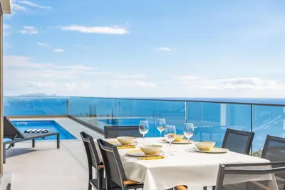 a table with wine glasses on a balcony with a view at Half Gate Villa in Gaula
