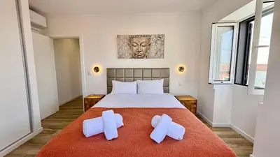 a bedroom with a bed and a large window at Villa Abundância in Arco da Calheta