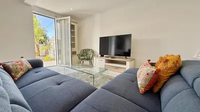 a kitchen with a counter and stools in it at Villa Abundância in Arco da Calheta