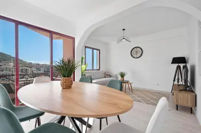 a dining room with a table and chairs at Casa Lobos in Câmara de Lobos