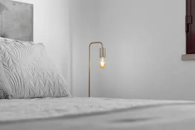 a bedroom with a bed with a lamp on it at Casa Lobos in Câmara de Lobos