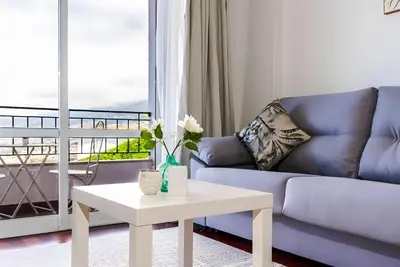 a living room with a couch and a table at City Views Apartment Funchal in Funchal
